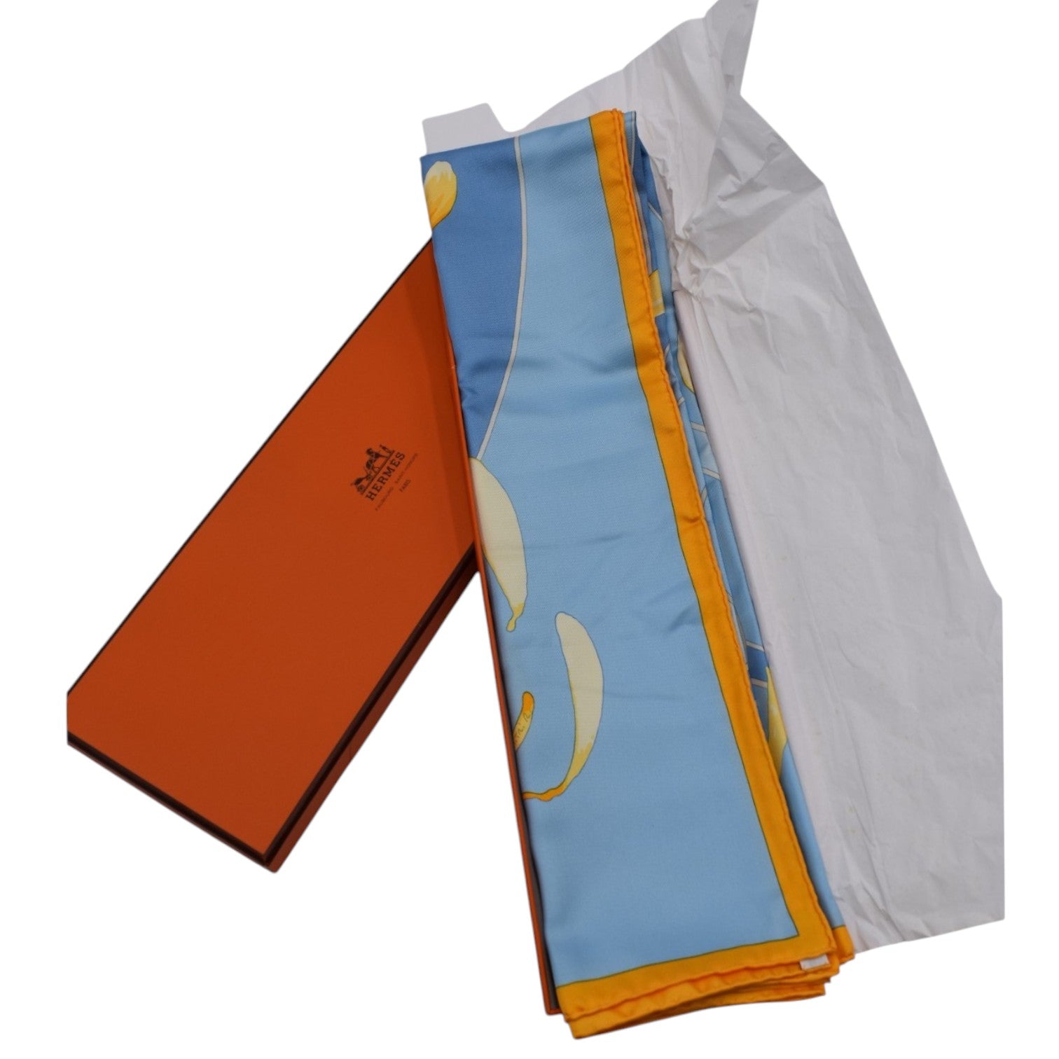 Soldi blue silk scarf with yellow flower petal design and orange border, presented in an orange box.