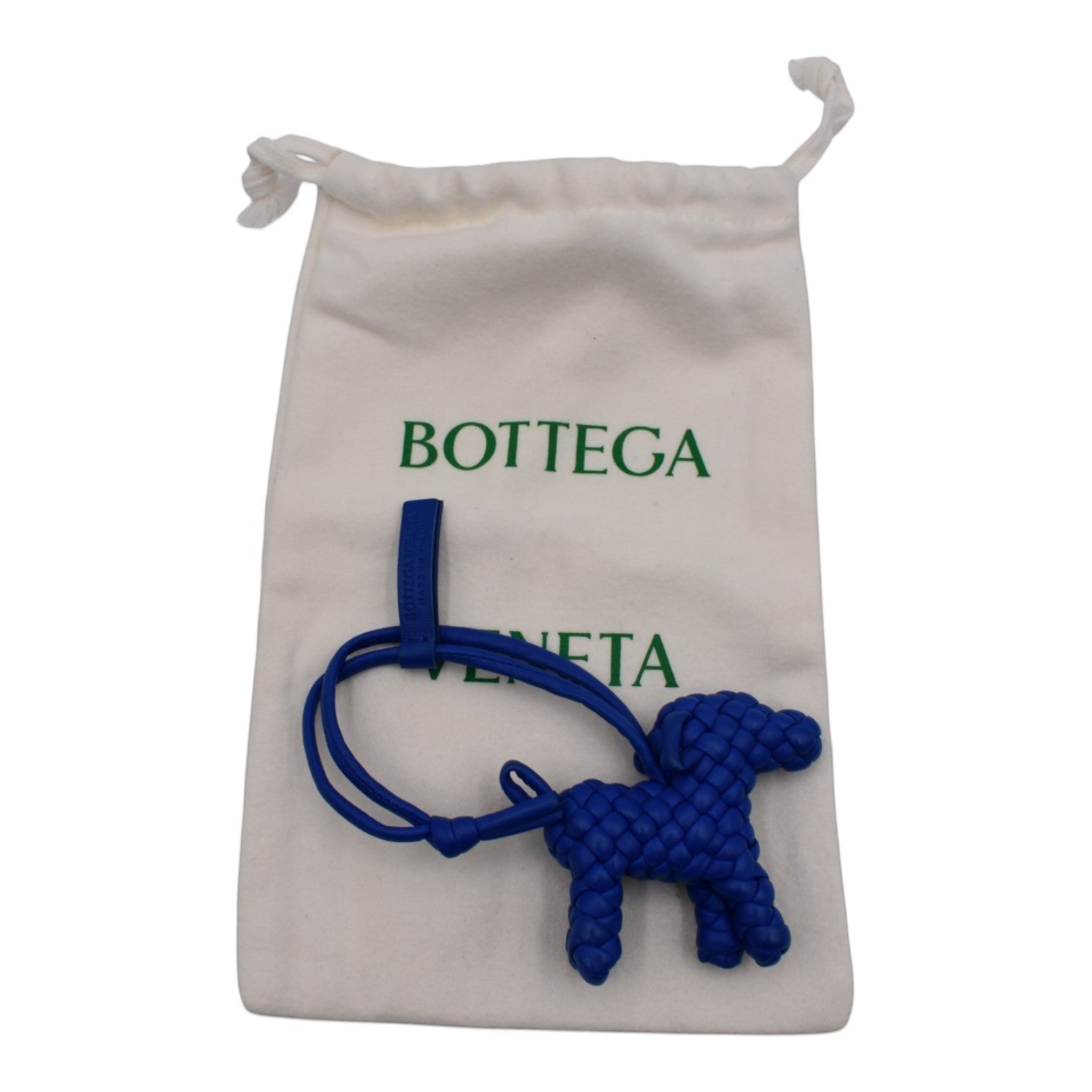 Soldi blue woven dog bag charm with loop and strap, presented with a white dust bag.
