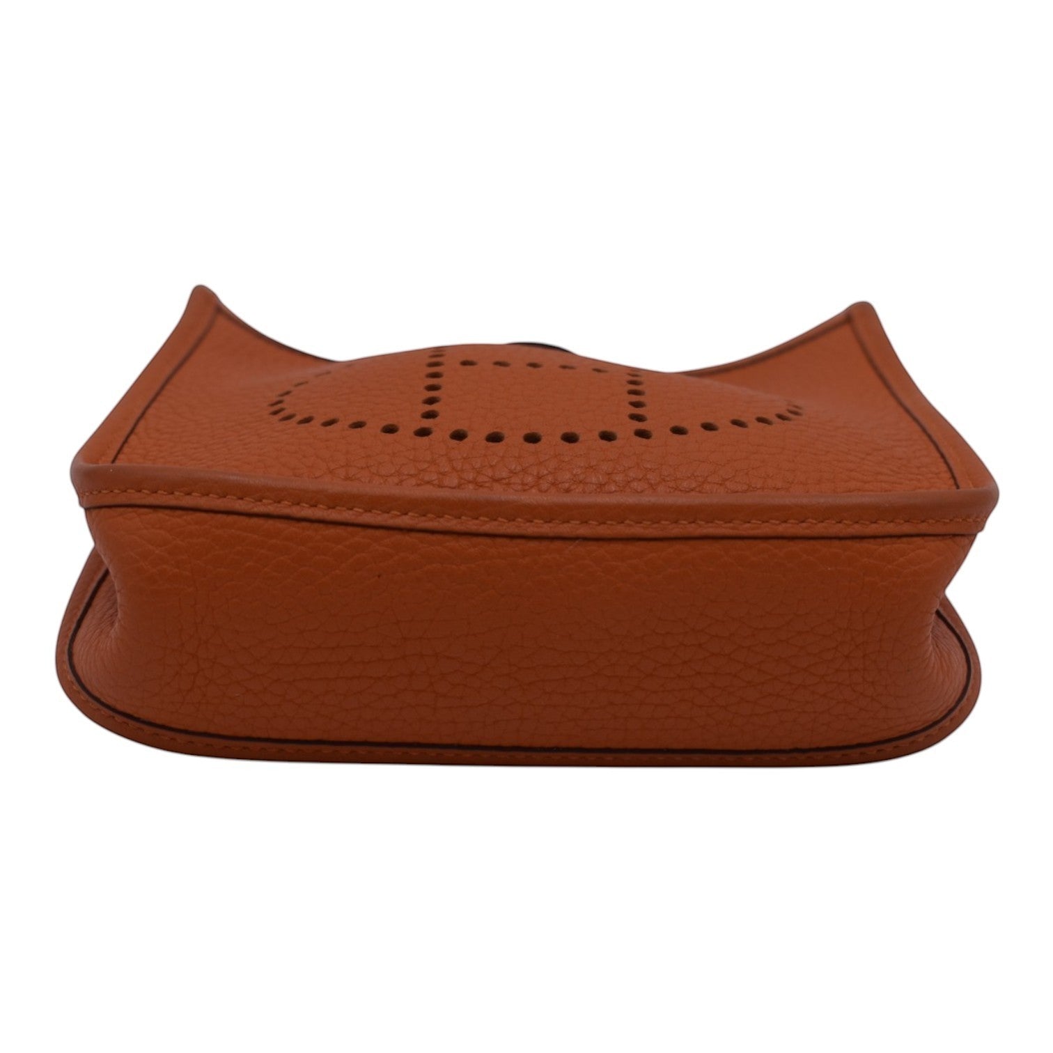 Soldi Hermes Mini Evelyn orange leather crossbody bag with perforated H detail and red strap.