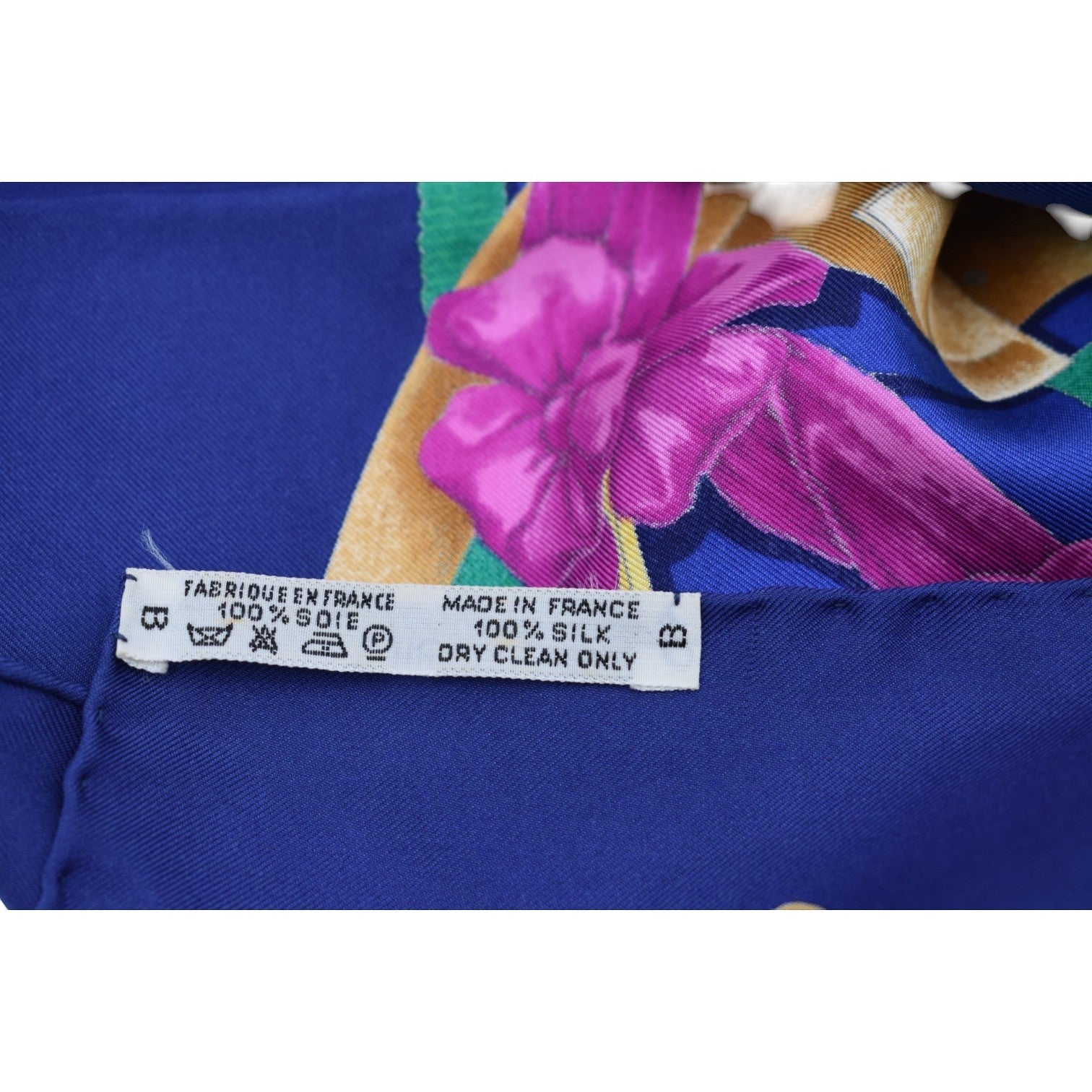 Soldi navy blue 100% silk scarf with a vibrant pink bow and floral print. Made in France.