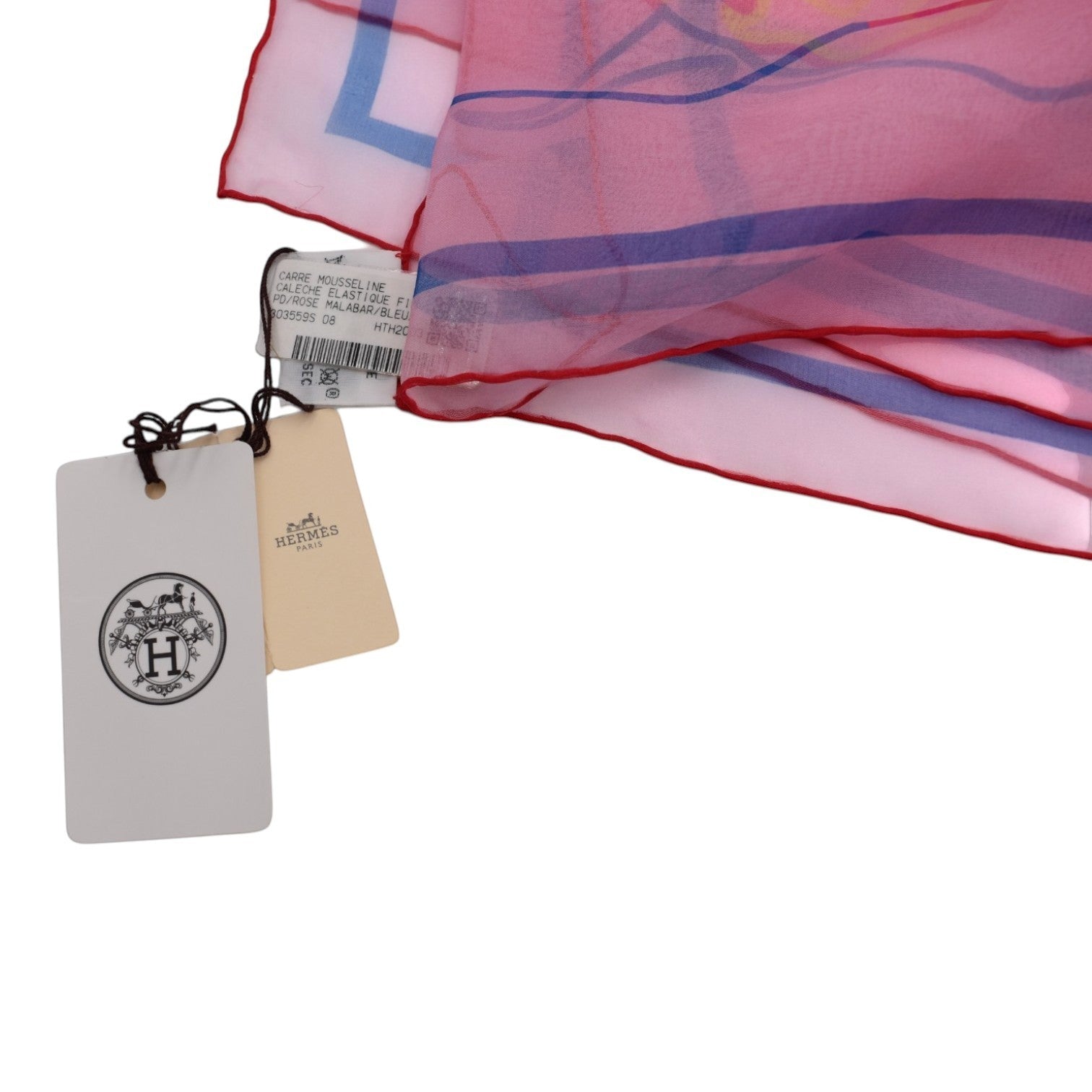 Soldi pink chiffon scarf with blue and white geometric pattern and red trim. Features a delicate, lightweight design.