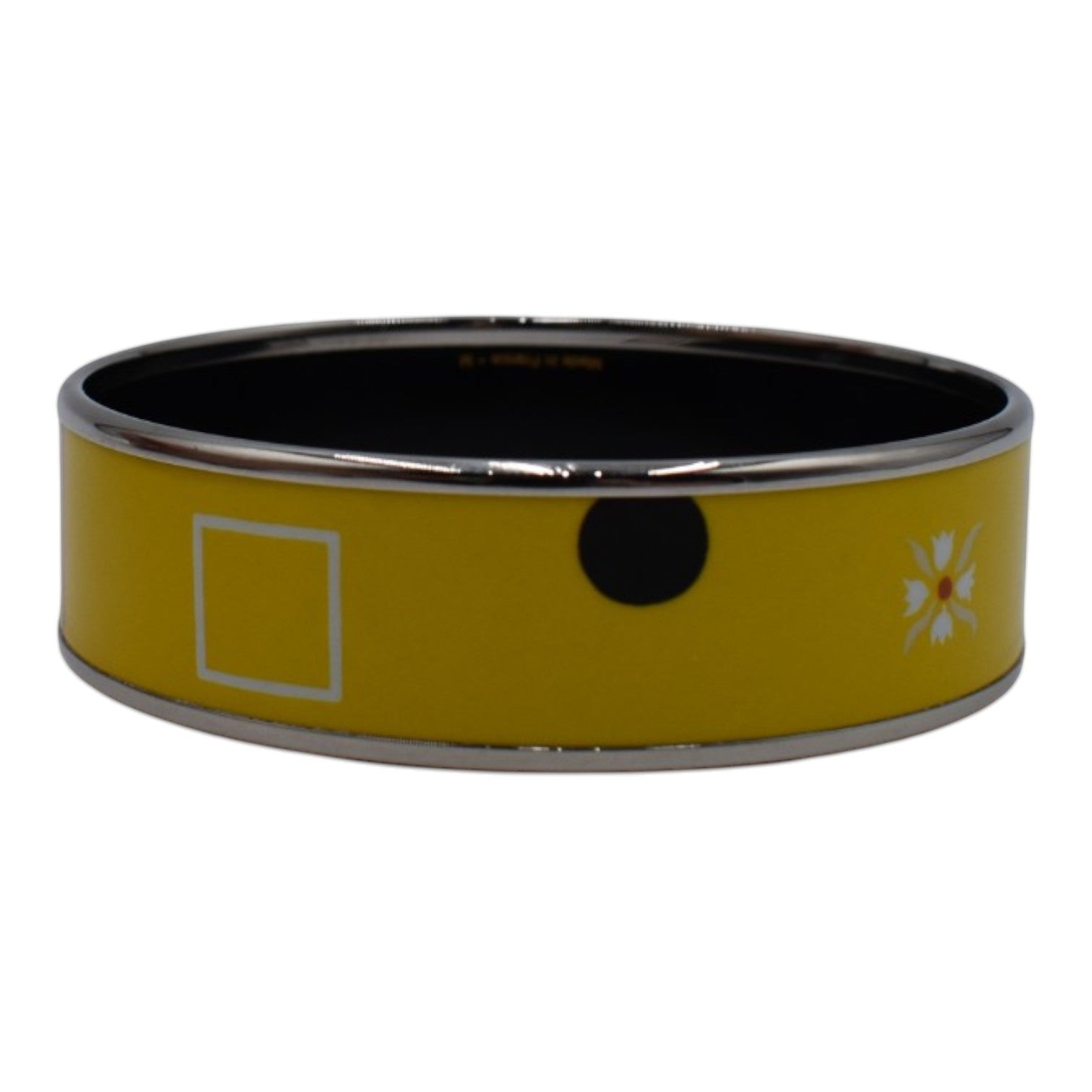 Soldi yellow bangle with white square, black circle, and floral motif. Enamel and metal.