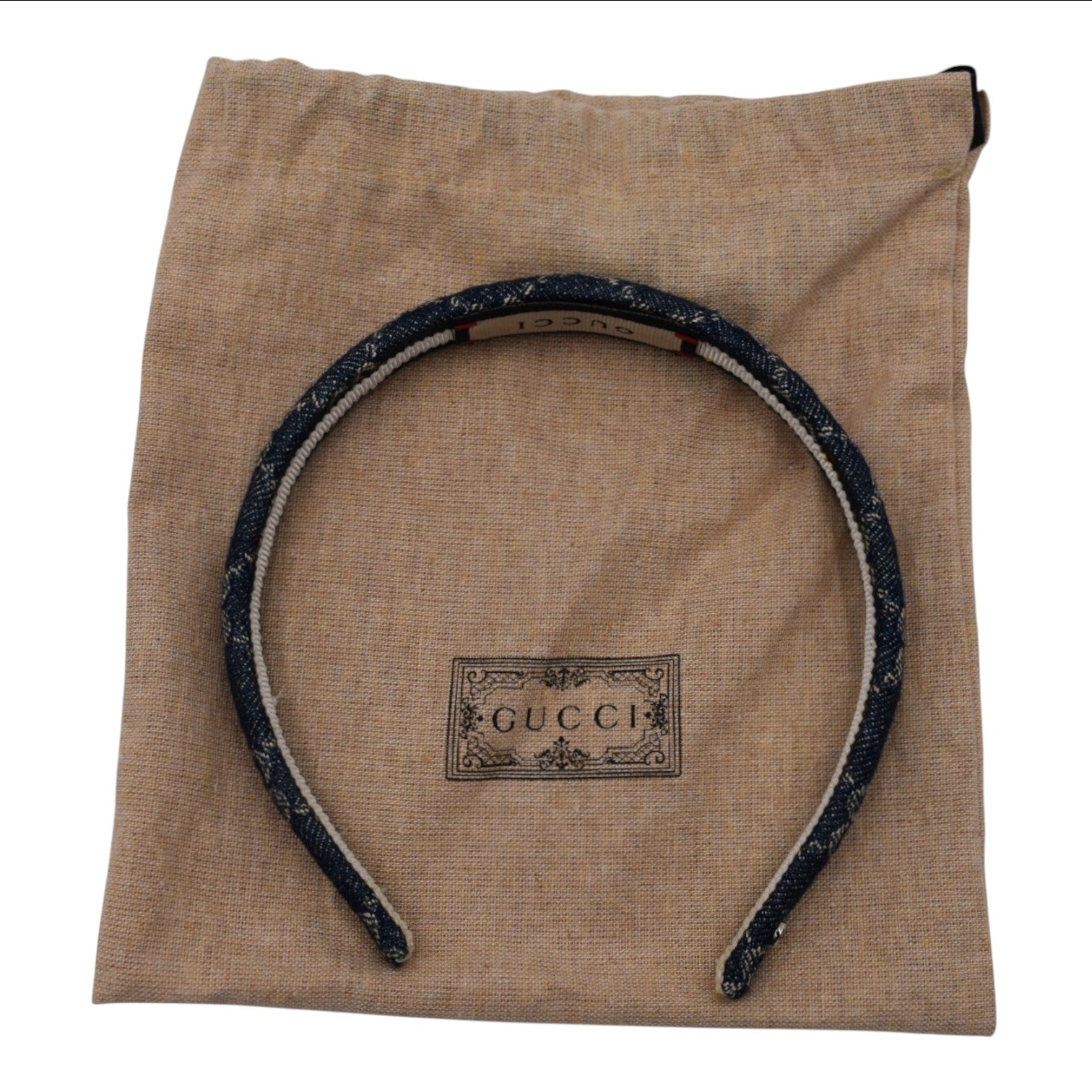 Soldi blue denim headband with white trim and Gucci logo detail on dust bag.