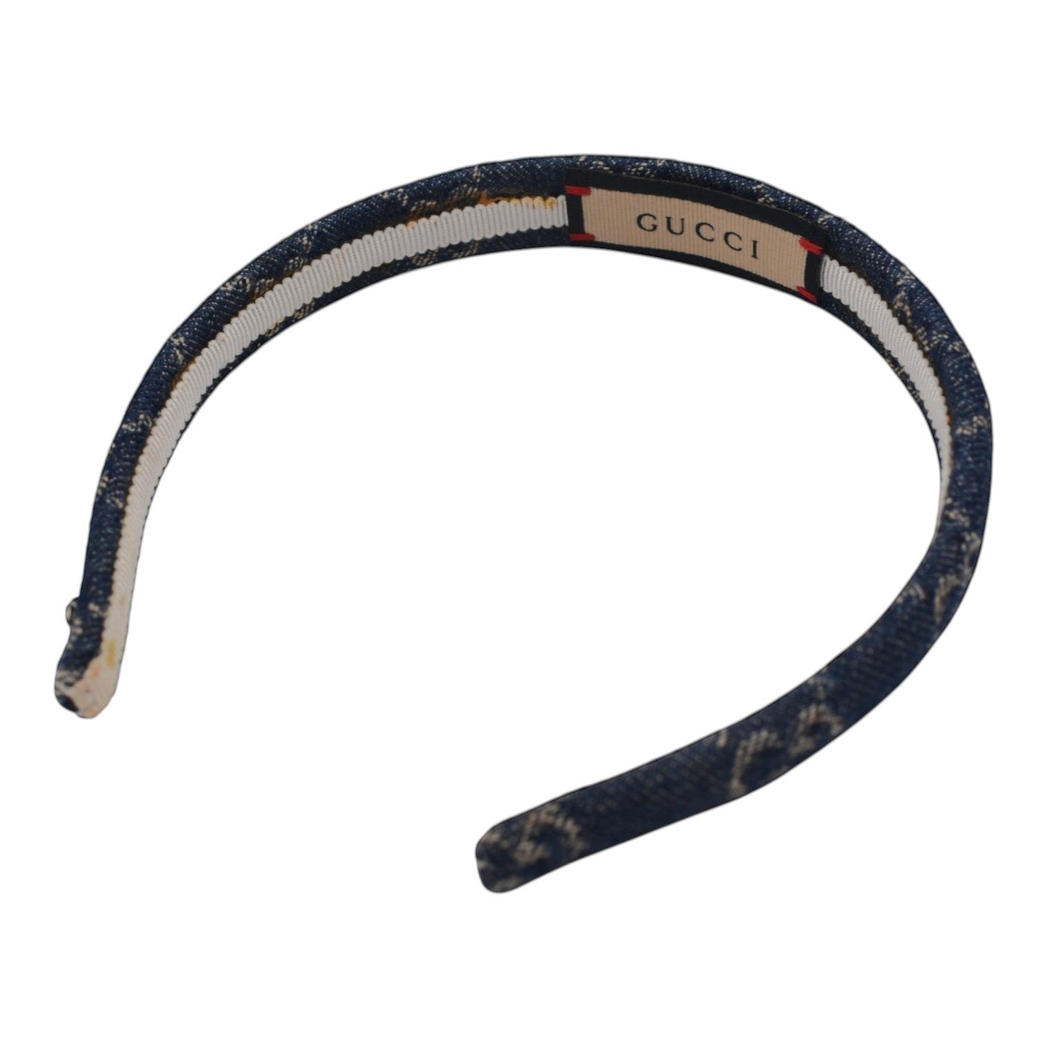 Soldi dark blue denim headband with a subtle pattern and white stripe detail, featuring a Gucci logo tag.