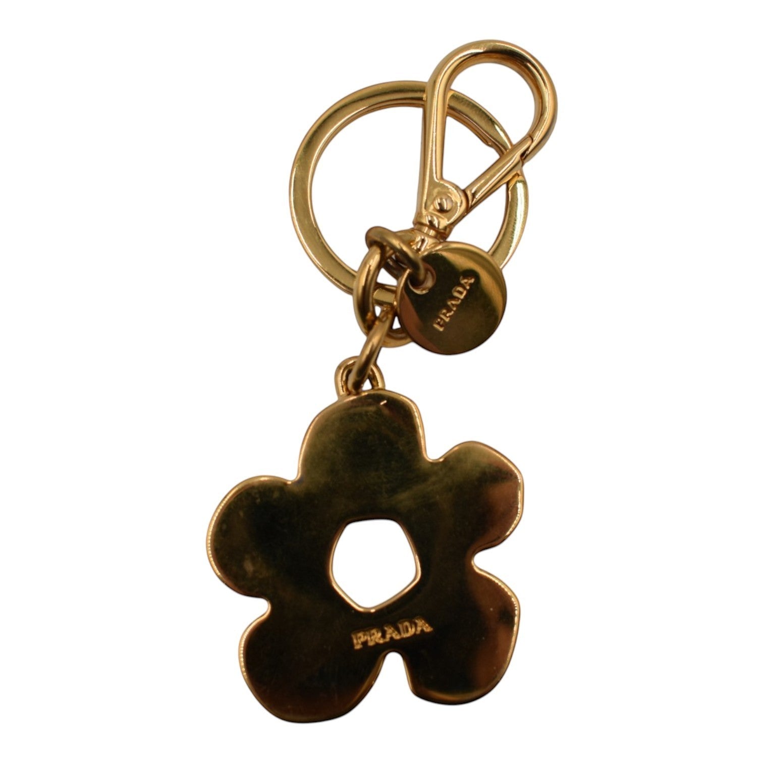 Soldi gold-tone flower bag charm with a circular keyring and lobster clasp. Features "PRADA" engraving.