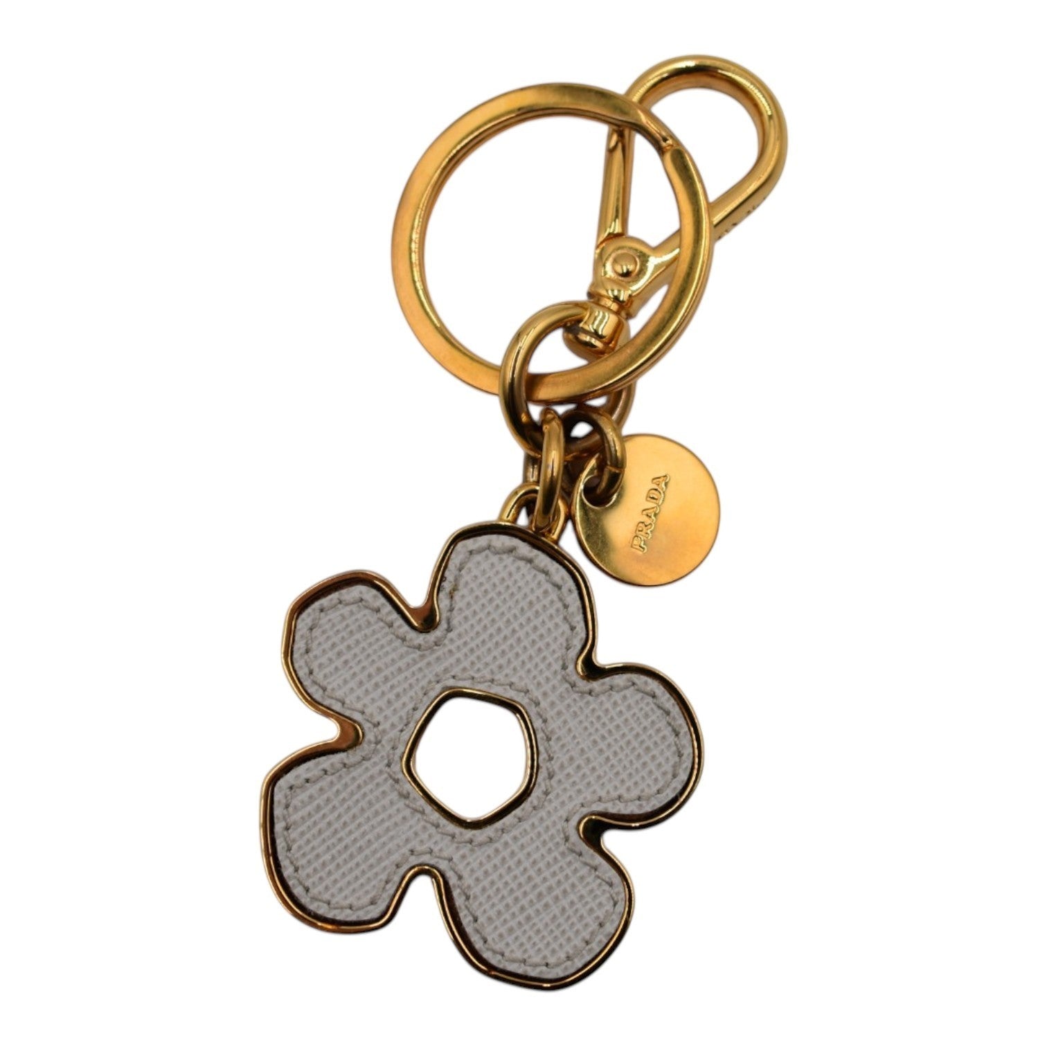 Soldi white leather flower bag charm with gold hardware and Prada logo tag.