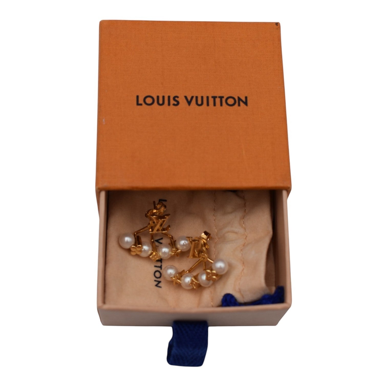 Soldi gold-tone cuff earrings with pearl drops and LV logo detail, presented in a Louis Vuitton box.